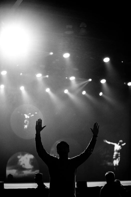 a man raising his arms in the air