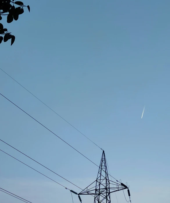 some very big electrical poles by some trees