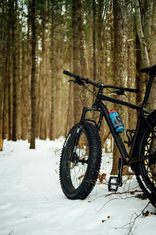 a bicycle that is parked in the snow