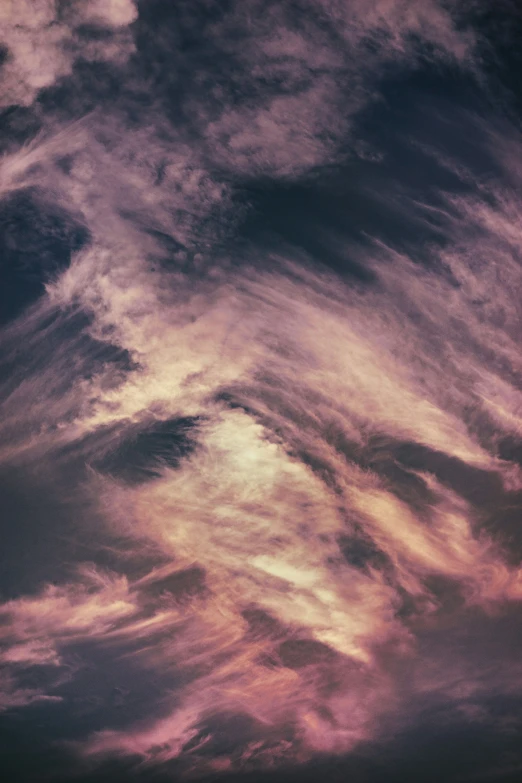 a po of an airplane wing against a cloudy sky