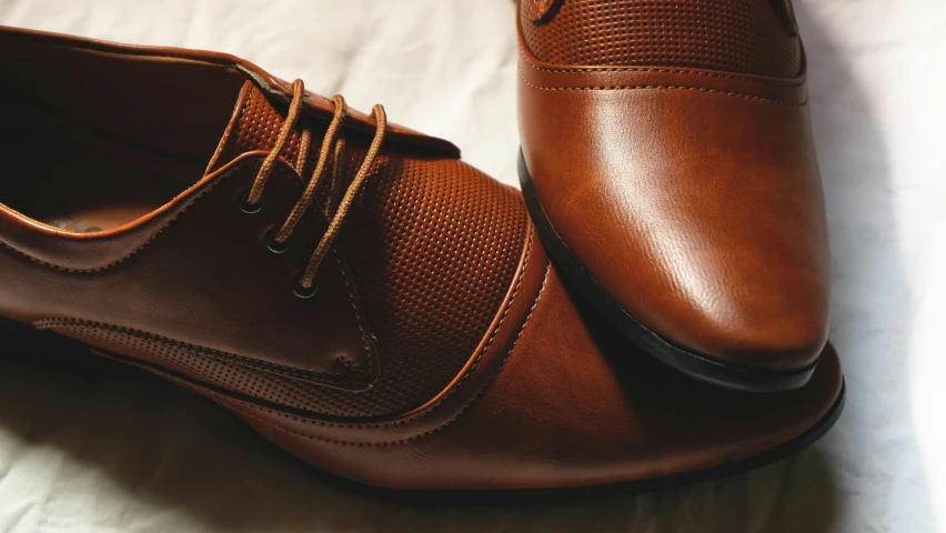 a pair of shoes are on top of a bed