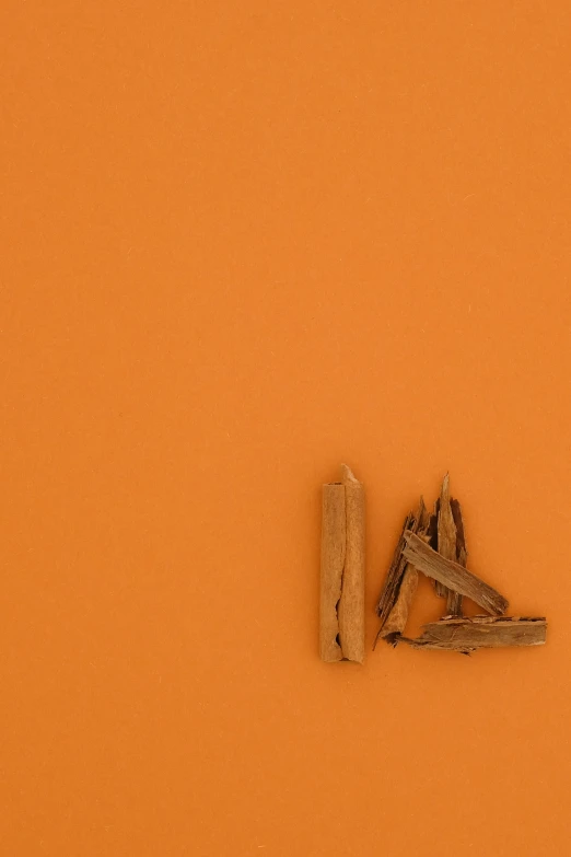 some type of piece of wood on an orange surface