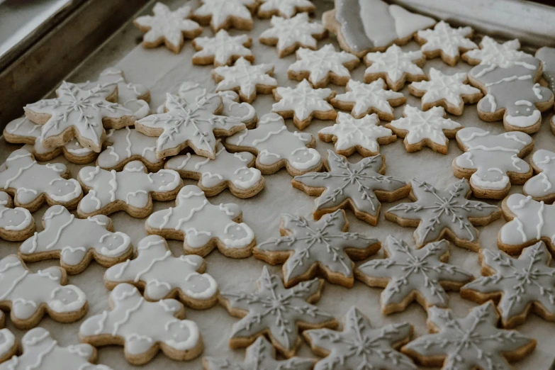 a group of white and grey iced cookies