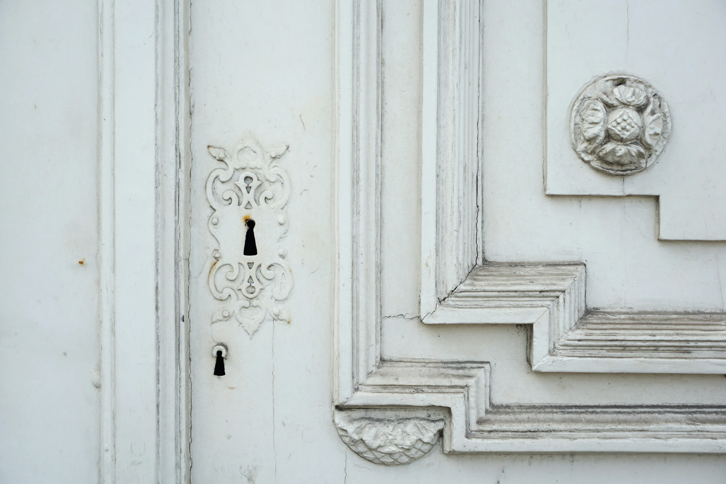 white decorative handles are displayed on the door