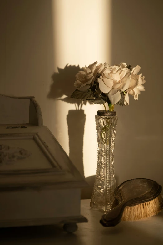 a white floral arrangement in a vase on a counter