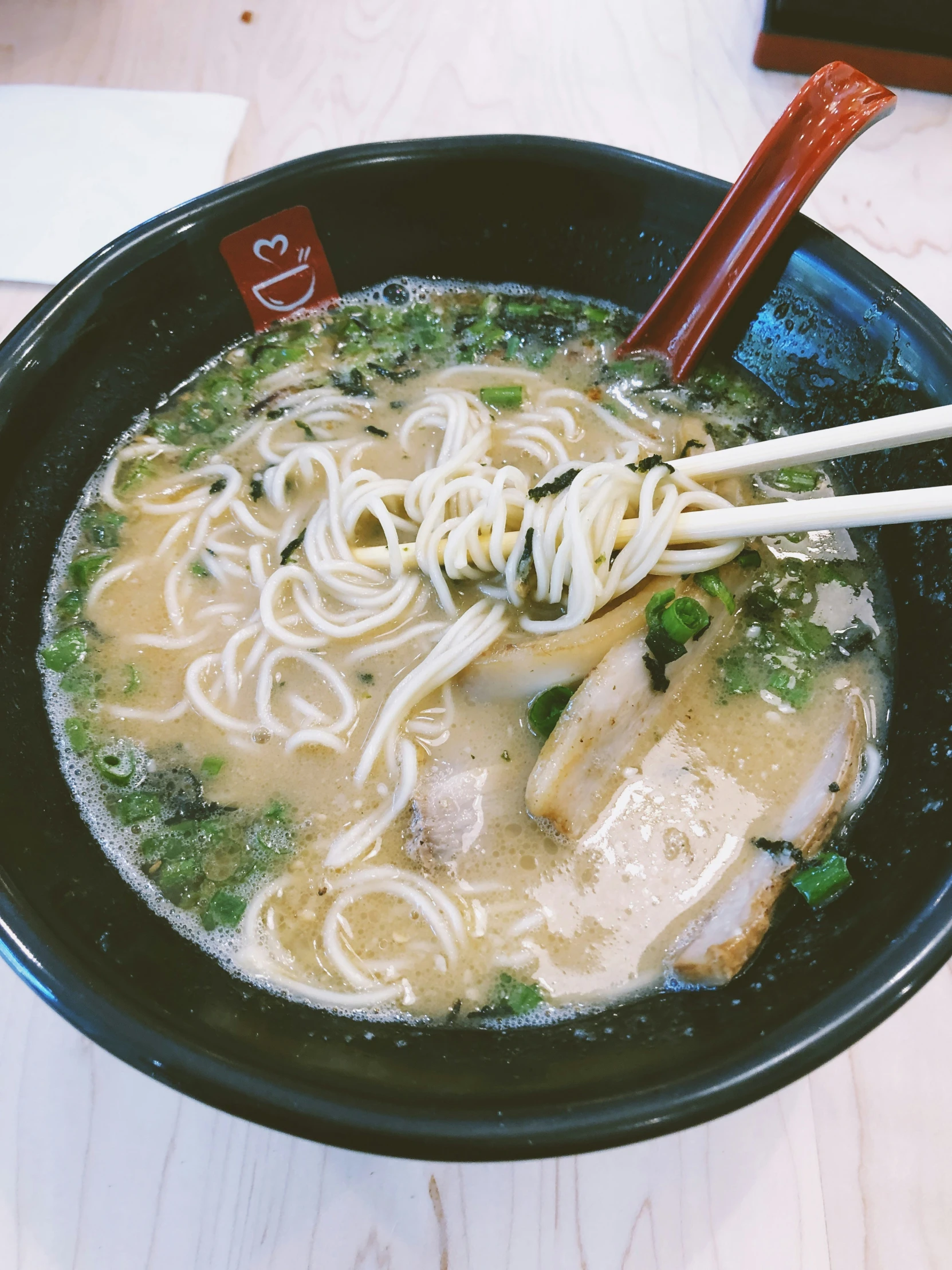 a bowl of noodles with chicken, veggies and broth