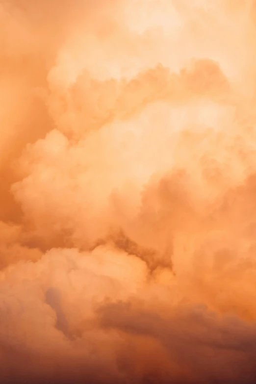 a plane flying in the distance, surrounded by clouds