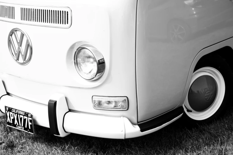 the front end of a vw bus parked in a field