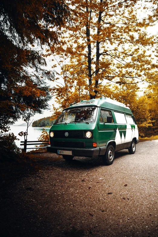 a van parked in the shade of a tree