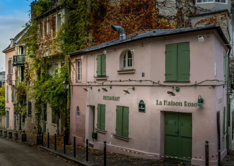 a pink building is seen with some ivy on it