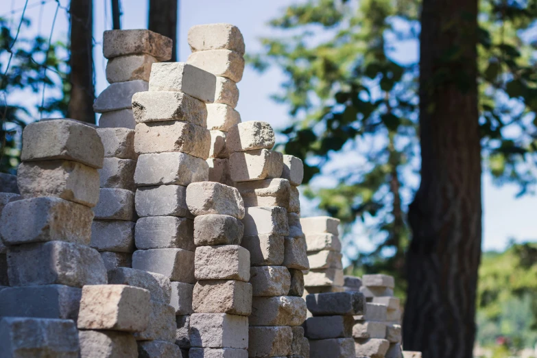 a pile of brick next to a tree