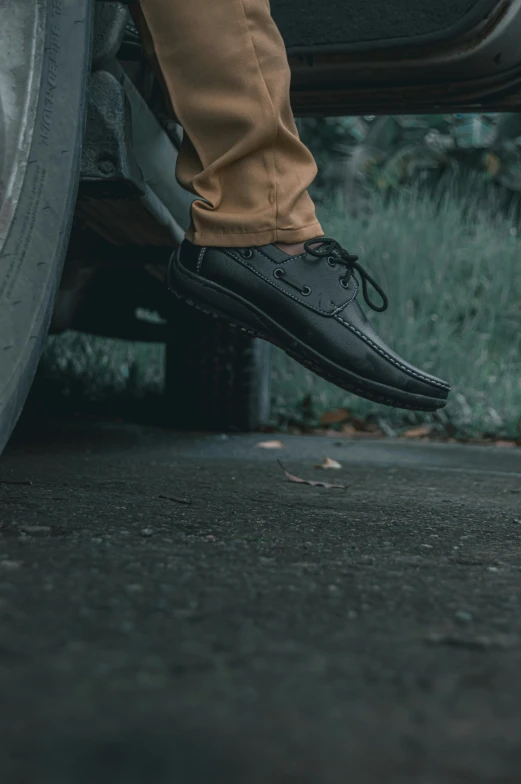 a person stepping on a car on the sidewalk