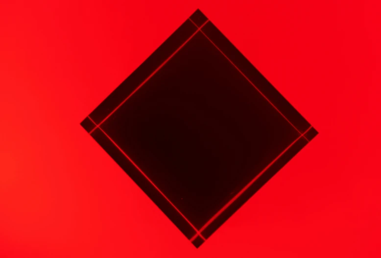 a red background with a black diamond in the middle