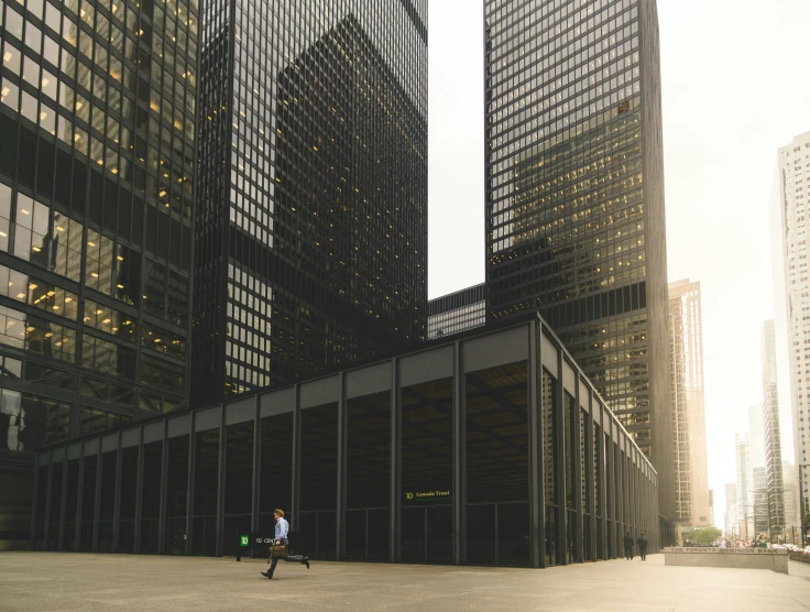 a person is walking by a very tall building