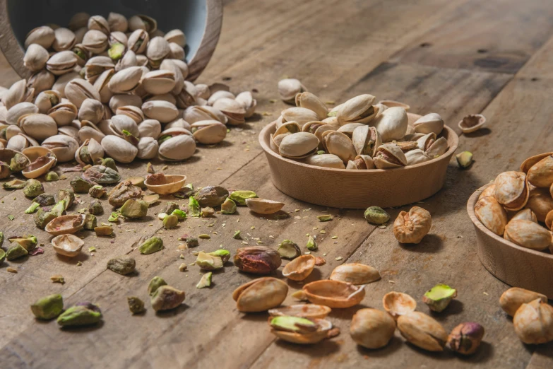 nuts are laying out on a wooden table