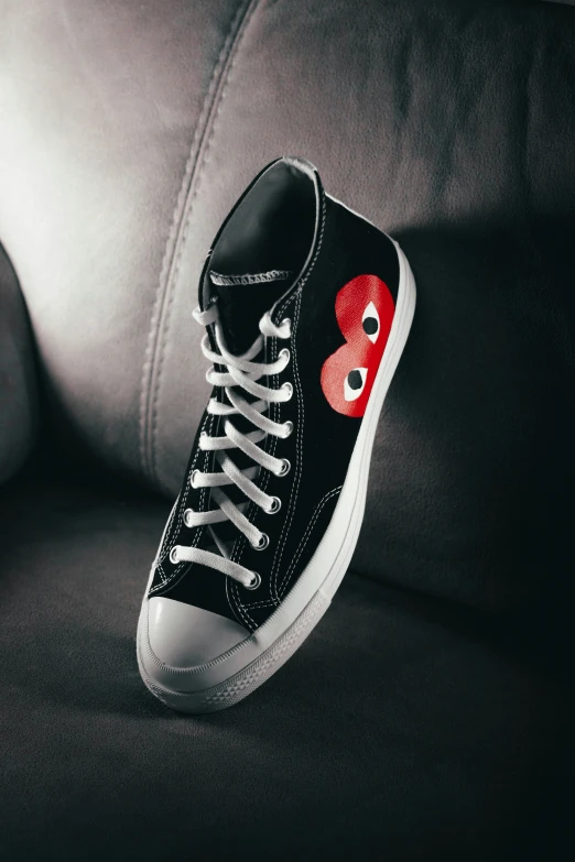 this pair of sneakers has red and white eyeballs on the side