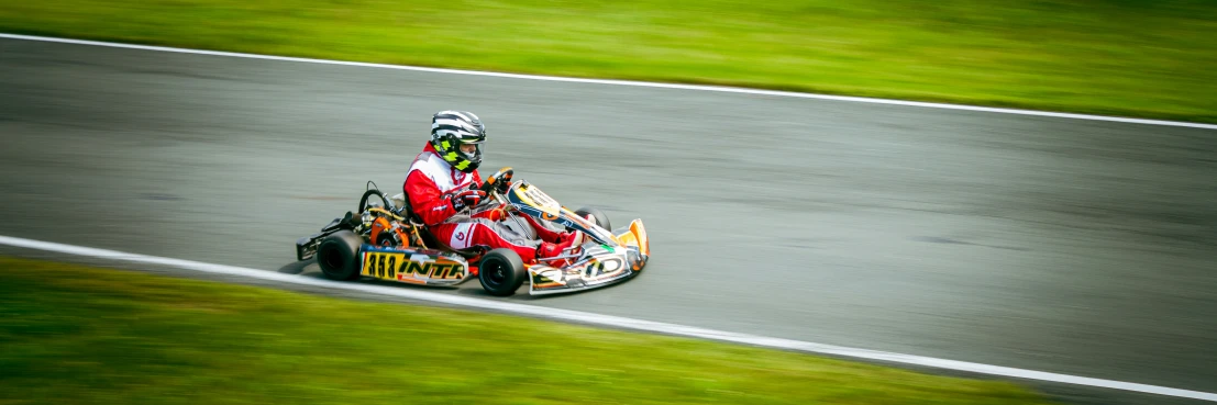 a person is riding a go kart race car