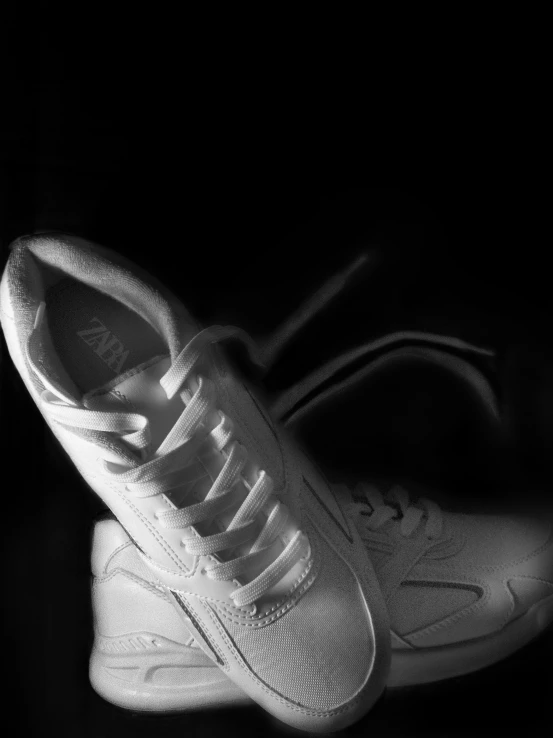 black and white pograph of a tennis shoe