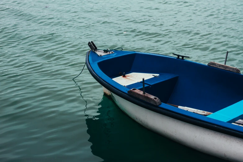 a boat tied up to a pier in the water