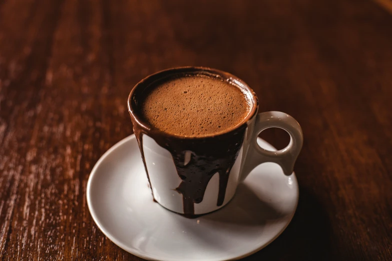 a cup with chocolate sauce and a spoon