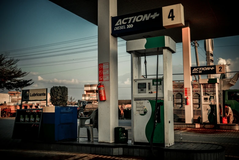 a gas station gas pumps next to other gas pumps