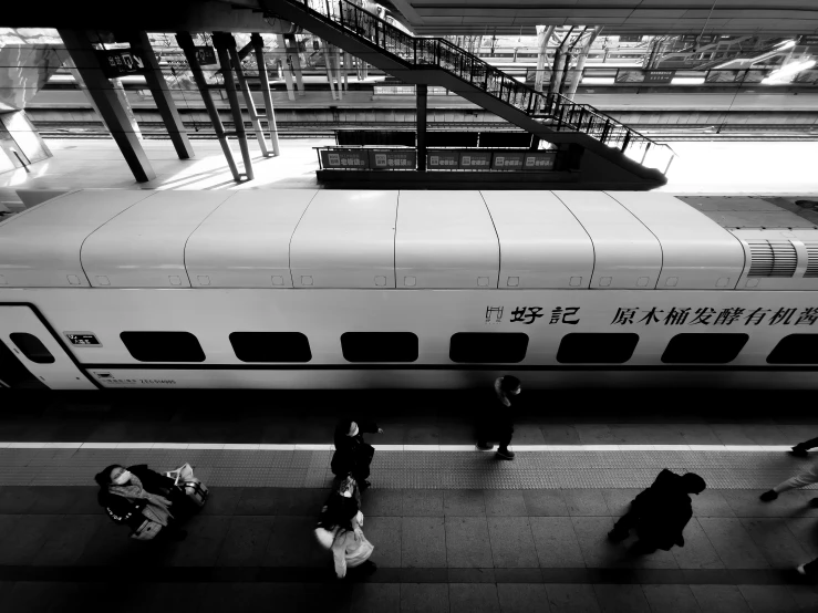 passengers are walking towards a parked train