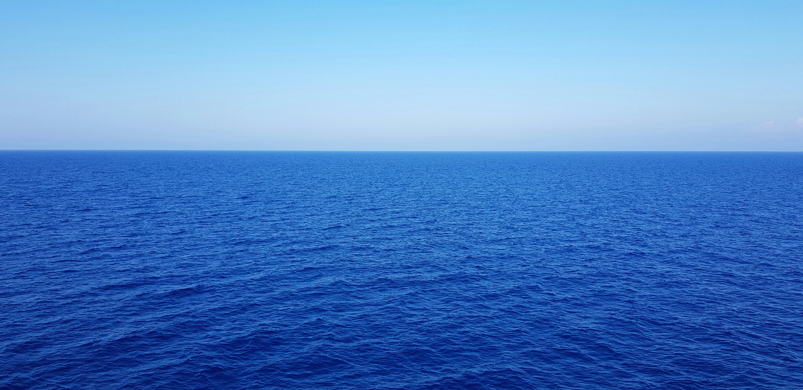 the ocean is blue and very wide, and it's blue