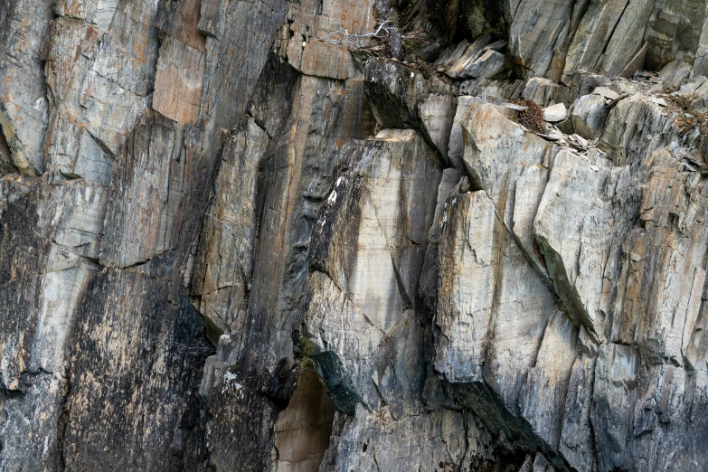 a rock climb with a large, rough - looking  in the side of it