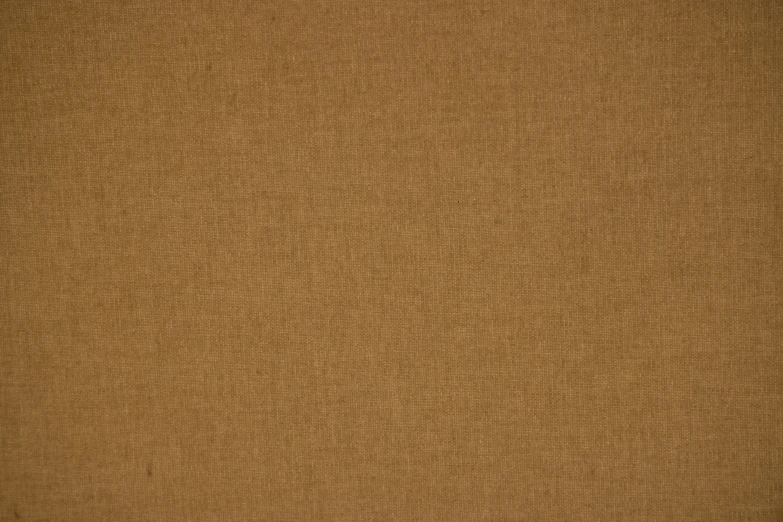 a close up view of the texture of a tan fabric
