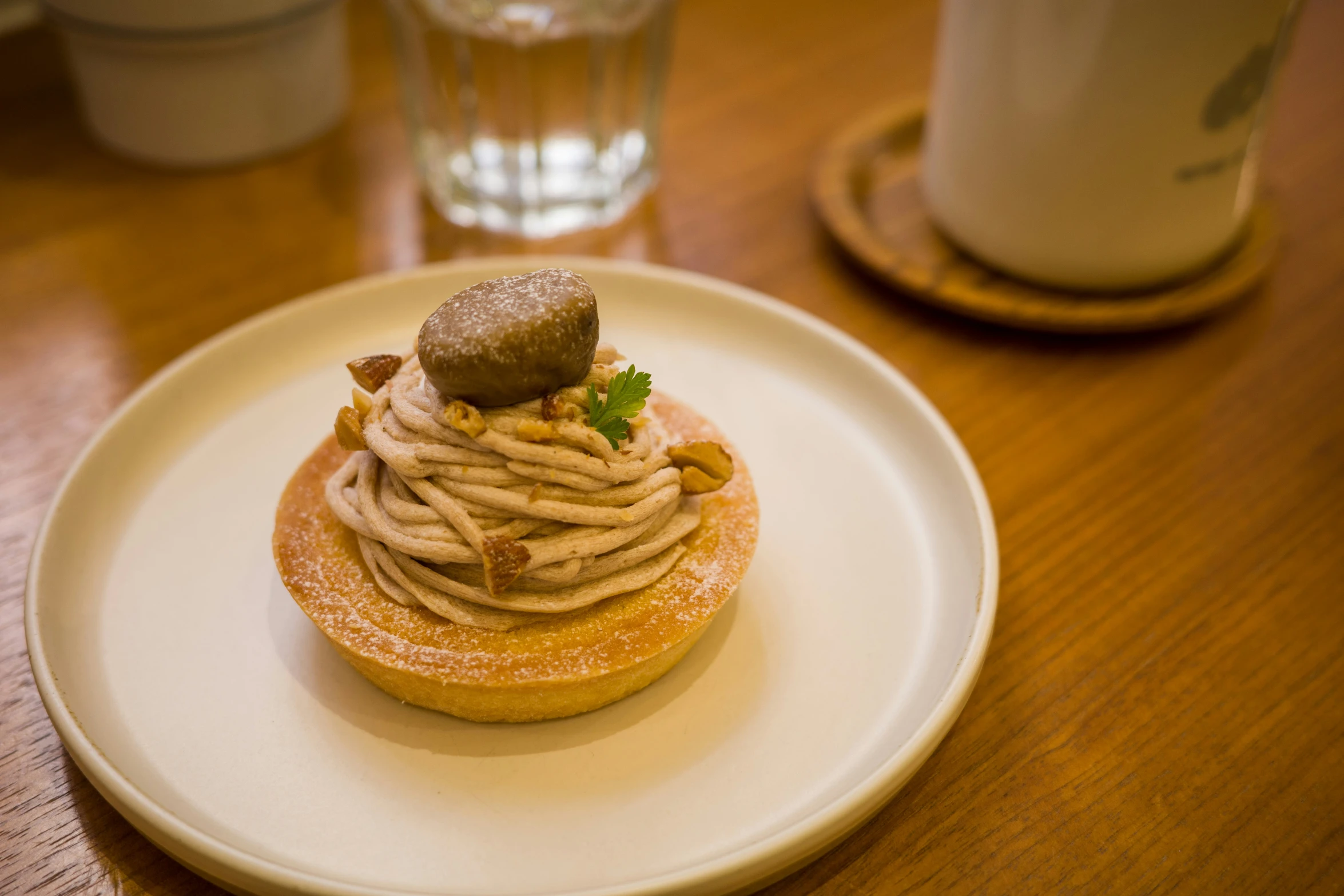 small pastry sits on the plate beside a coffee cup