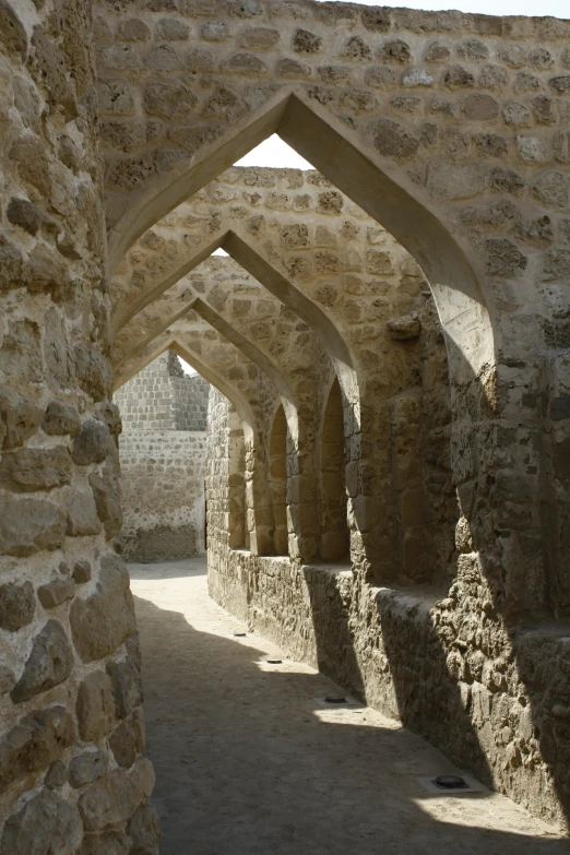 the interior of an old building with many stone arches