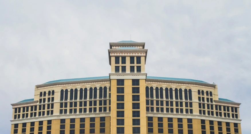 a tall yellow building sitting on top of a green field