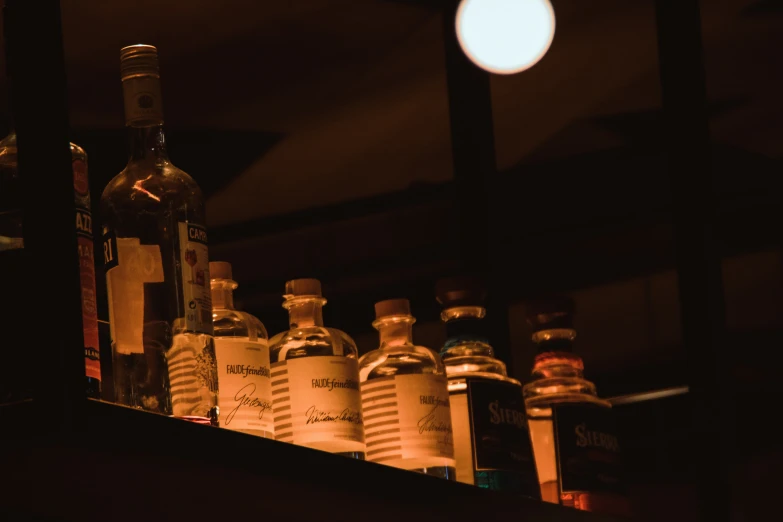 bottles are on the shelf, and one in dark