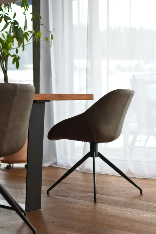 a brown chair sitting next to a table