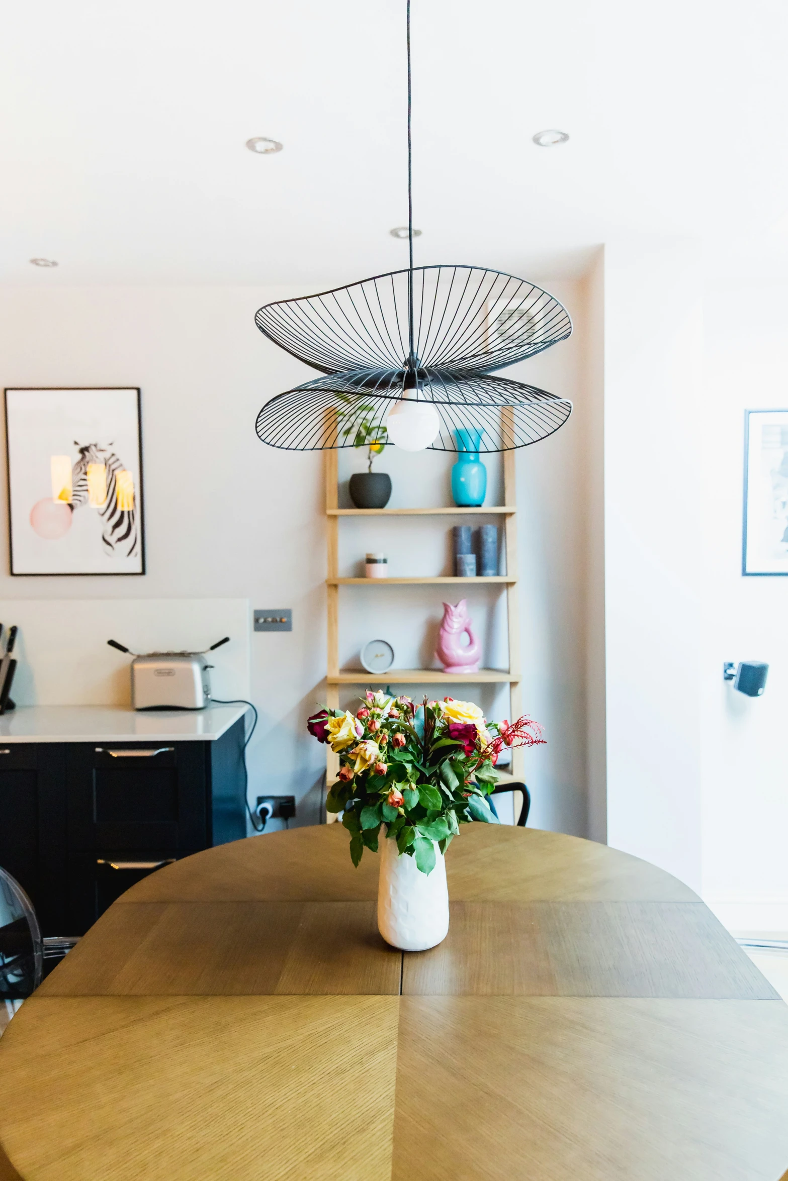 a vase with flowers in it sits on a table