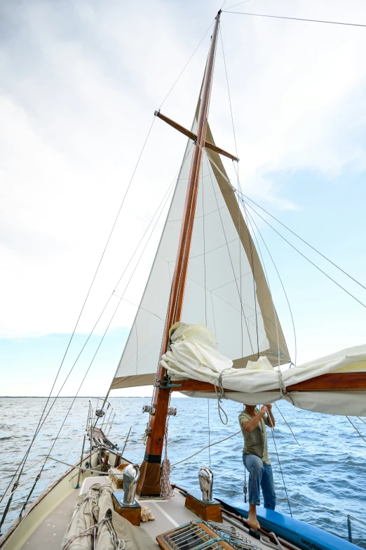 an individual in view from the cockpit of a sailboat