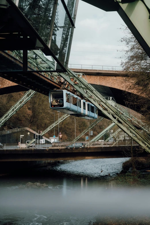 a modern passenger train traveling across a bridge