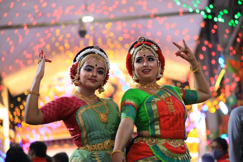 two girls dressed up in colorful costumes on a street