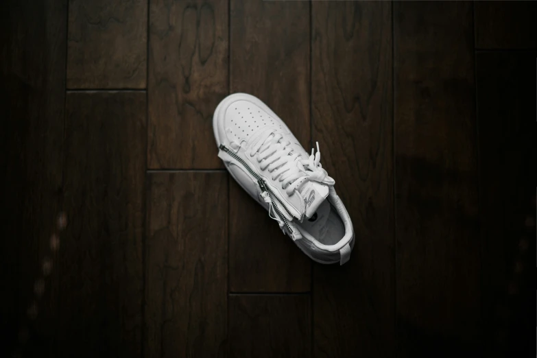 a white pair of sneakers on the ground with no one standing