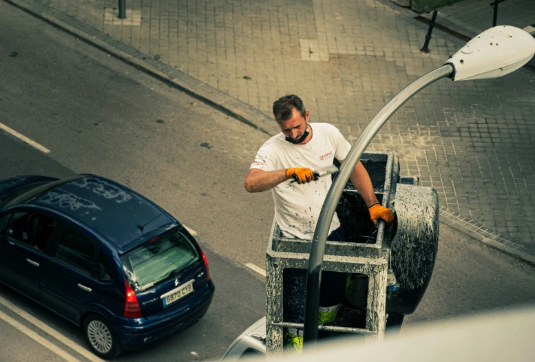 a man in white shirt standing near the top of a cart