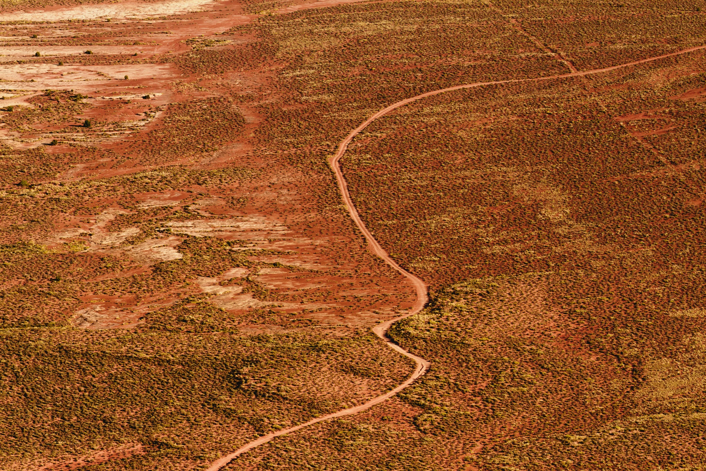 aerial view of dirt land with large mountains