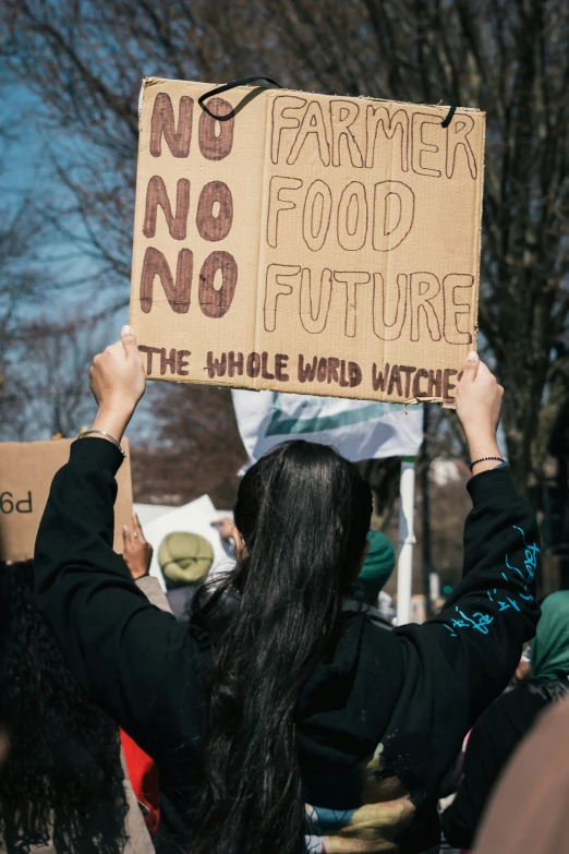 people holding signs and protest signs with writing