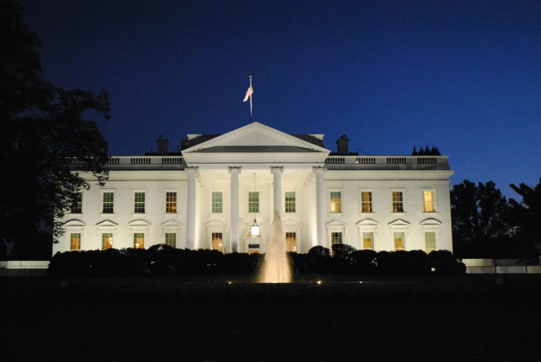 a large white building is lit up at night