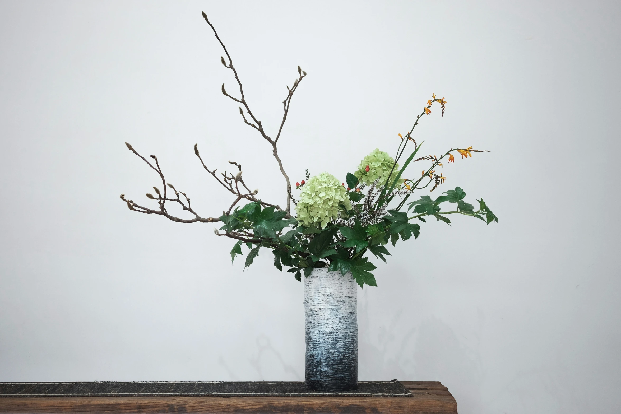 a vase filled with flowers on top of a table