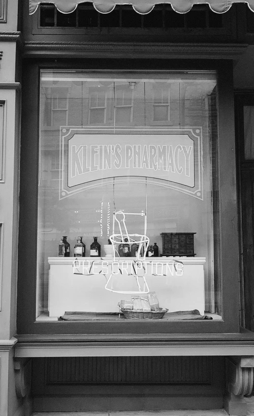 a store front window displays a lighted sign