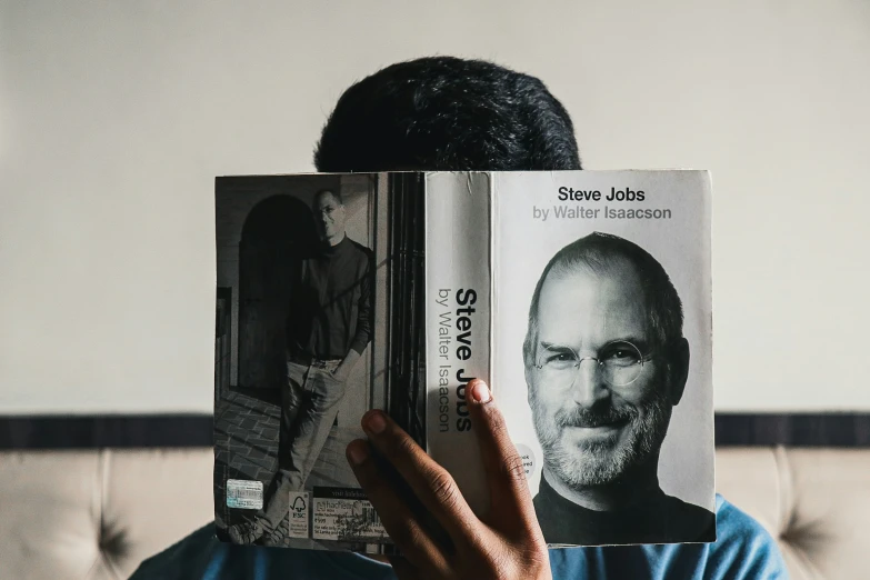 a man holds his face to his books