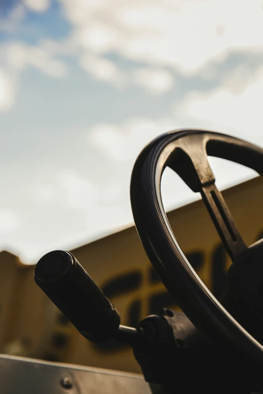 the steering wheel and drivers seat of a yellow truck