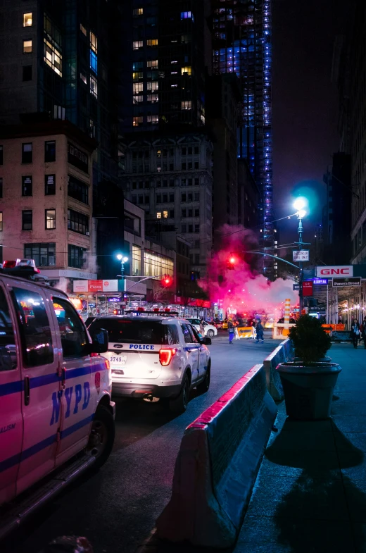 cars sit parked on the street during a city street party