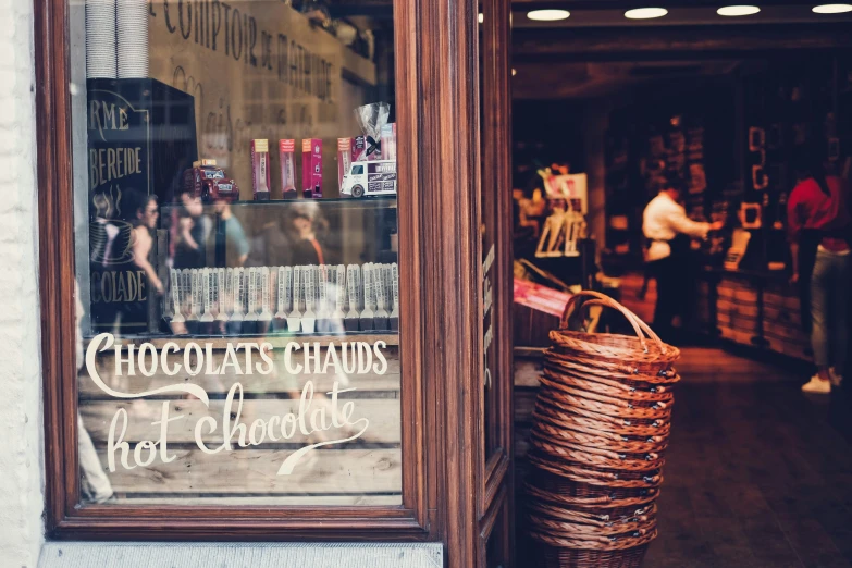 a store with a window sign for chocolates shops