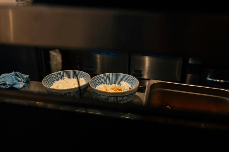 two plates that have food in them by a stove